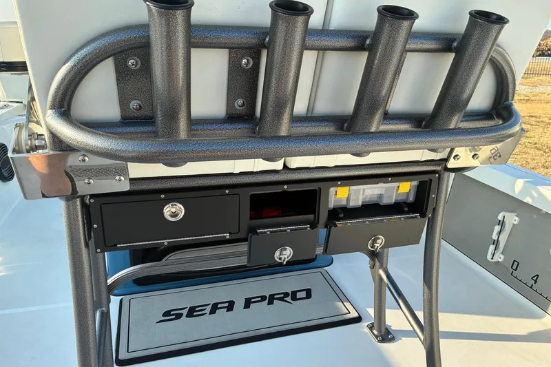 Slide: The Image of 2026 Sea Pro 250 Bay boat with rod holders and storage compartments. - 18