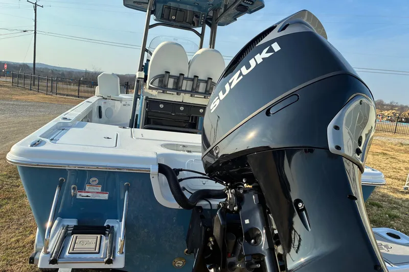 Slide: The Image of 2026 Sea Pro 250 Bay boat with Suzuki outboard motor, rear view. - 2