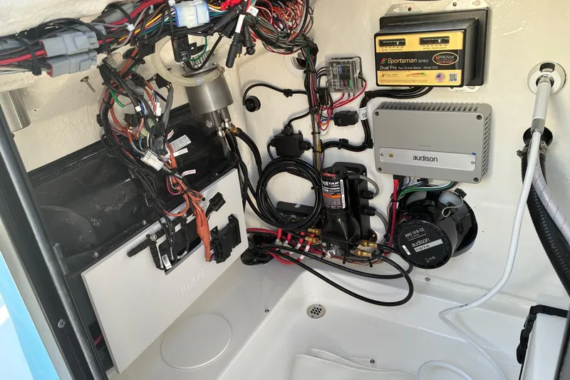 Slide: The Image of Interior view of 2026 Sea Pro 250 Bay boat's electrical and audio system components. - 22