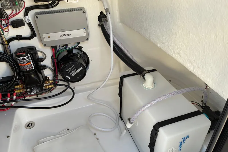 Slide: The Image of 2026 Sea Pro 250 Bay boat interior showing wiring and equipment installation. - 23