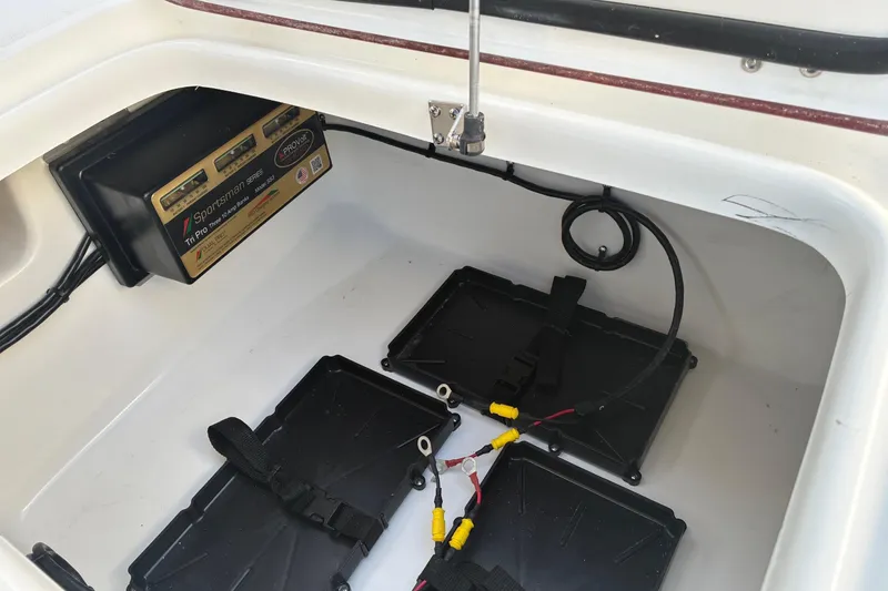 Slide: The Image of Battery compartment of 2026 Sea Pro 250 Bay boat with charger and wiring. - 24