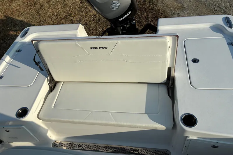 Slide: The Image of 2026 Sea Pro 250 Bay boat with cushioned seating and storage compartments. - 26