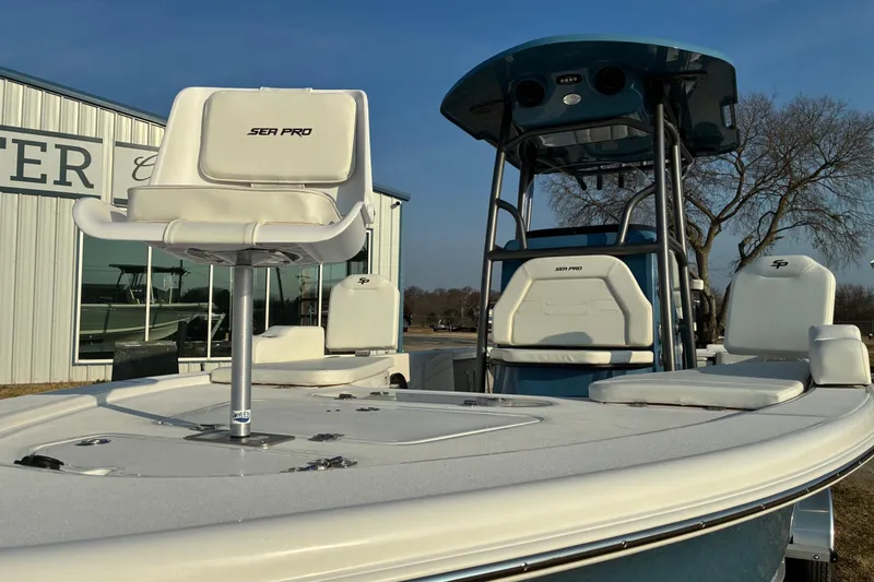 Slide: The Image of 2026 Sea Pro 250 Bay boat with white seating and sleek design. - 6