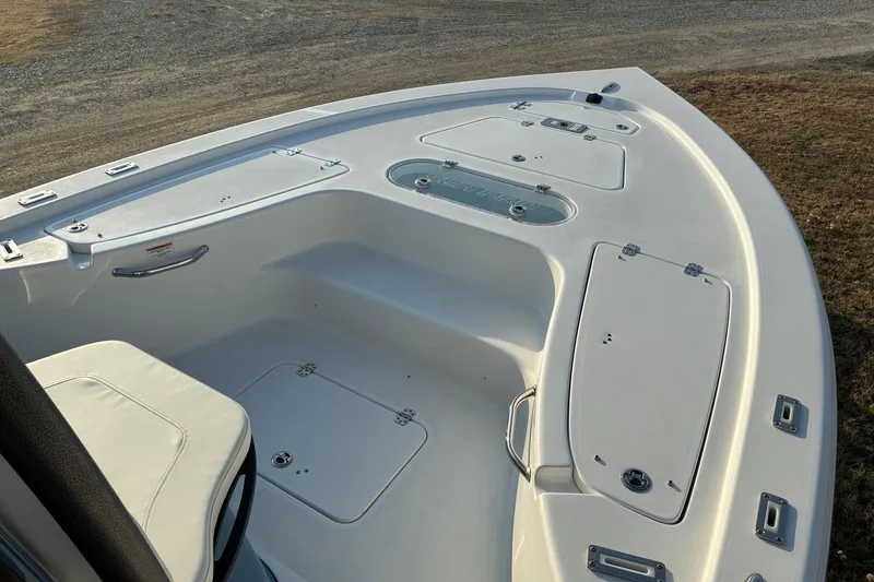 Slide: The Image of 2026 Sea Pro 250 Bay boat deck with storage compartments and seating. - 7