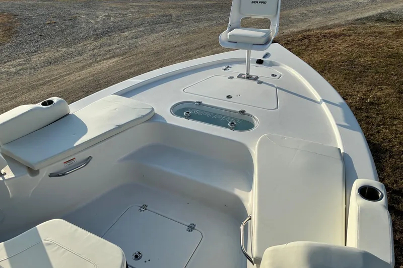Slide: The Image of 2026 Sea Pro 250 Bay boat interior with seating and storage compartments. - 8