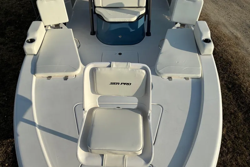 Slide: The Image of 2026 Sea Pro 250 Bay boat interior with cushioned seating and cup holders. - 9