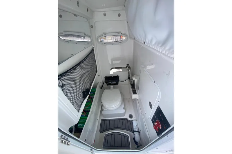Slide: The Image of 2021 Sea Hunt Gamefish 27 boat interior with toilet and storage compartments. - 10