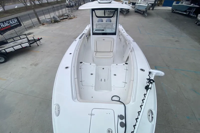 Slide: The Image of 2021 Sea Hunt Gamefish 27 boat with forward seating, docked in a marina. - 13