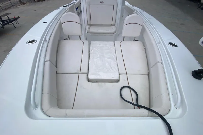 Slide: The Image of 2021 Sea Hunt Gamefish 27 Forward Seating with white cushioned seats and storage area. - 15