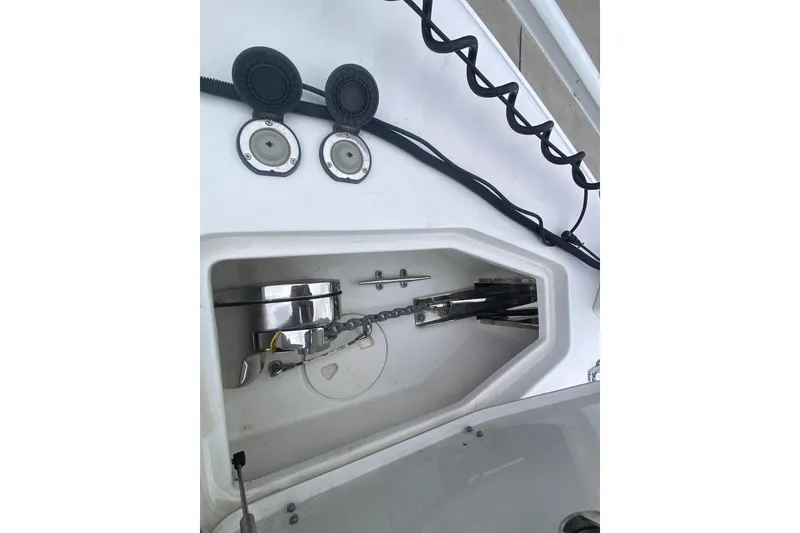 Slide: The Image of 2021 Sea Hunt Gamefish 27 anchor compartment with chain and winch system. - 16
