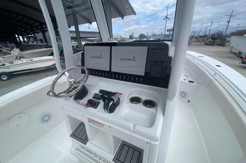 Slide: The Image of 2021 Sea Hunt Gamefish 27 helm with Garmin displays and steering wheel. - 19