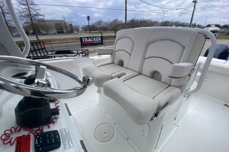 Slide: The Image of 2021 Sea Hunt Gamefish 27 boat interior with forward seating and steering wheel. - 22