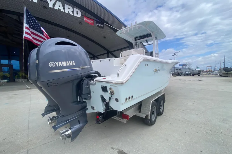 Slide: The Image of 2021 Sea Hunt Gamefish 27 boat with Yamaha engine, parked at a boatyard. - 3
