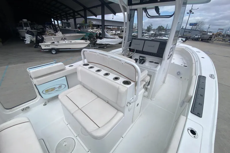 Slide: The Image of 2021 Sea Hunt Gamefish 27 boat with forward seating, docked in a marina. - 31
