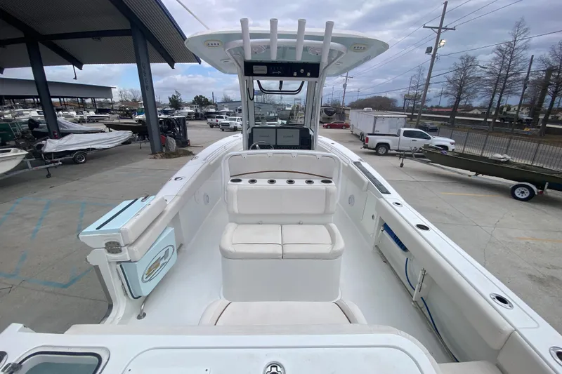 Slide: The Image of 2021 Sea Hunt Gamefish 27 boat with forward seating, docked in a marina. - 32
