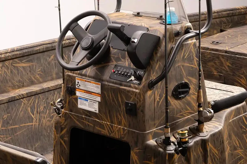 Slide: The Image of 2026 G3 Gator Tough 20 CC boat interior with camo design and fishing rods. - 4