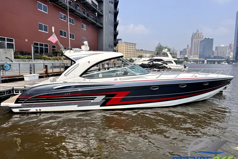 The Image of 2014 Formula 400 FX8 boat docked in urban marina, sleek design with red accents. - 0