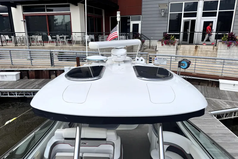 Slide: The Image of 2014 Formula 400 FX8 boat docked, featuring sleek design and American flag. - 15