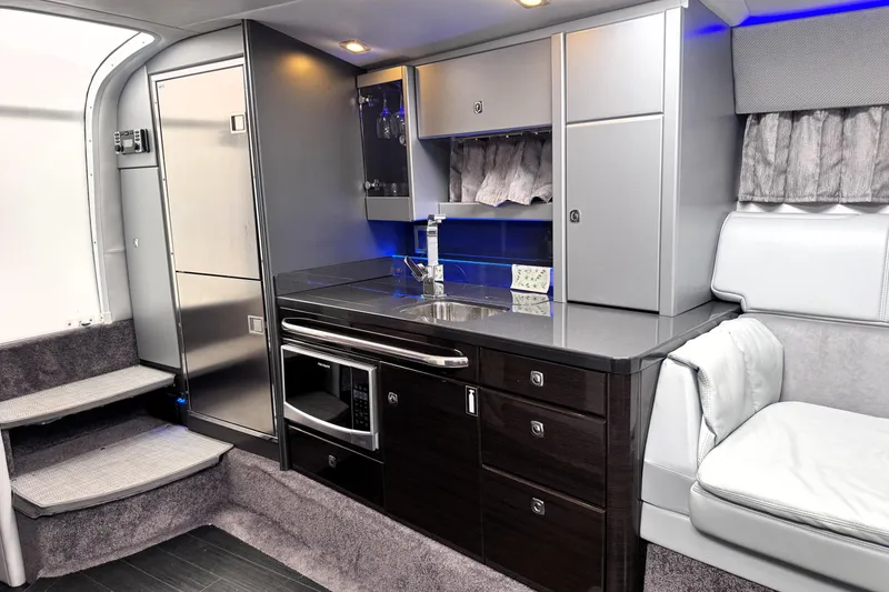 Slide: The Image of Luxurious interior of 2014 Formula 400 FX8 boat with modern kitchenette and seating area. - 18
