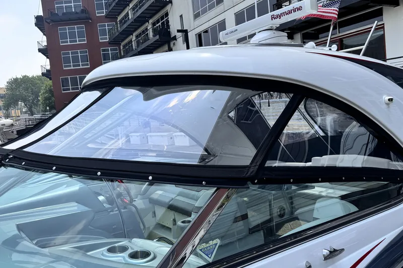 Slide: The Image of 2014 Formula 400 FX8 boat with Raymarine equipment, docked near modern buildings. - 35