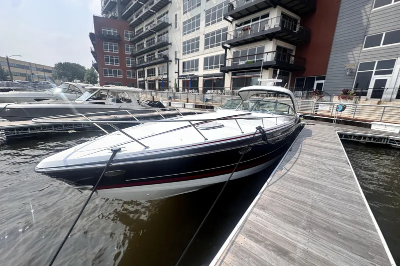 Slide: The Image of 2014 Formula 400 FX8 boat docked at a marina near modern buildings. - 4