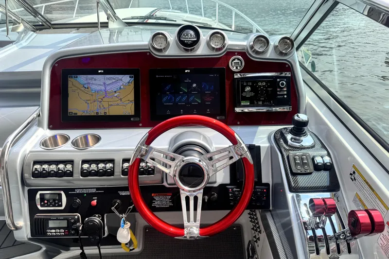 Slide: The Image of Dashboard of 2014 Formula 400 FX8 boat with red steering wheel and navigation screens. - 40