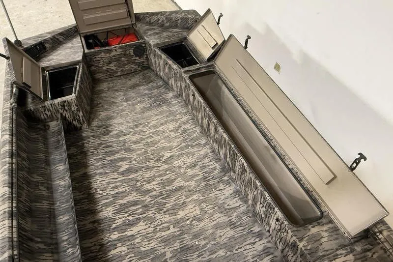 Slide: The Image of 2026 Havoc 1756 MRST boat interior with open storage compartments and camouflage design. - 8