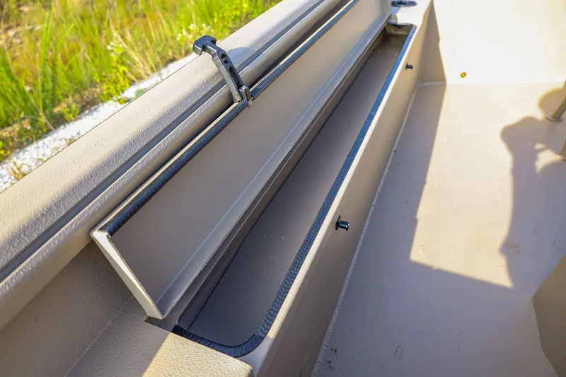 Slide: The Image of 2026 Excel Switchblade boat storage compartment with open lid, showcasing interior space. - 13