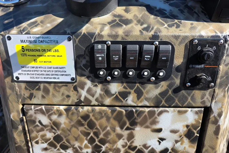 Slide: The Image of Control panel of 2026 Excel Switchblade boat with capacity and safety labels. - 16