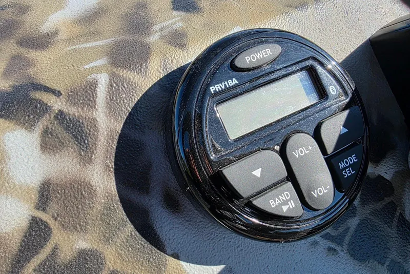 Slide: The Image of Control panel of 2026 Excel Switchblade with camouflage background, featuring buttons and display. - 17