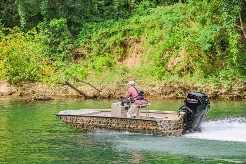 Slide: The Image of 2026 Excel Switchblade boat cruising on a scenic river with lush green surroundings. - 23