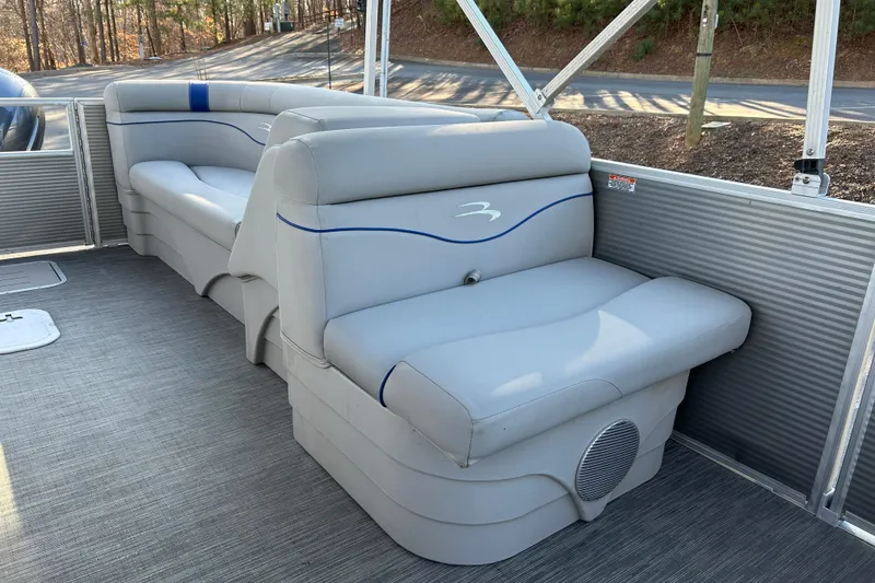 Slide: The Image of 2023 Bennington 22 SSRX pontoon boat with gray seating and blue accents. - 12