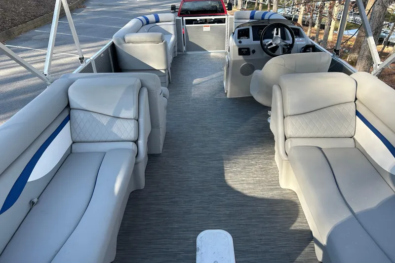 Slide: The Image of 2023 Bennington 22 SSRX pontoon boat interior with plush seating and steering console. - 15