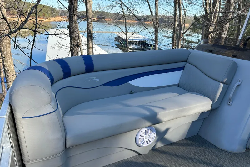 Slide: The Image of 2023 Bennington 22 SSRX pontoon boat interior with gray seating and lake view. - 17