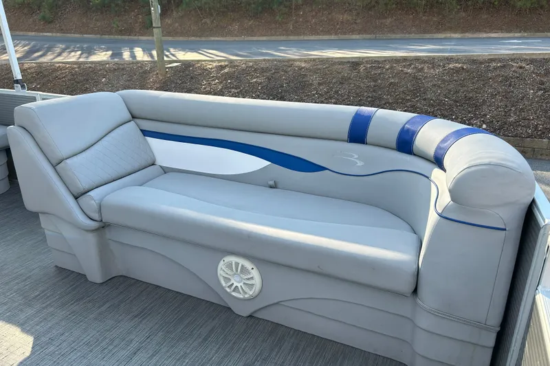 Slide: The Image of 2023 Bennington 22 SSRX boat interior with gray and blue cushioned seating. - 18