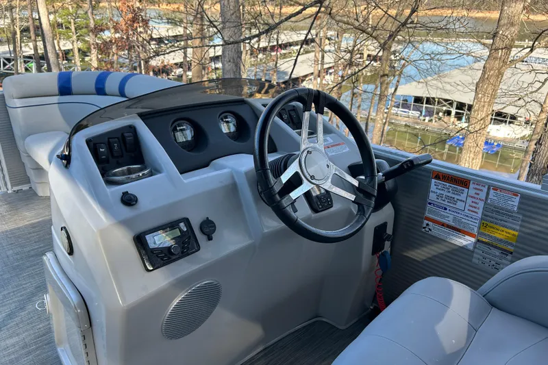 Slide: The Image of 2023 Bennington 22 SSRX boat dashboard with steering wheel and control panel. - 9