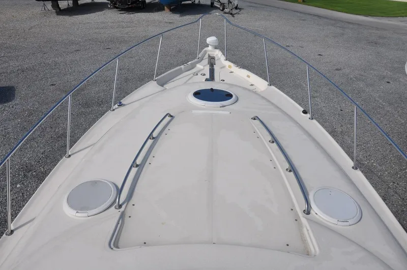 Slide: The Image of 2006 Monterey 322 Cruiser bow view with deck hatches and railings. - 12