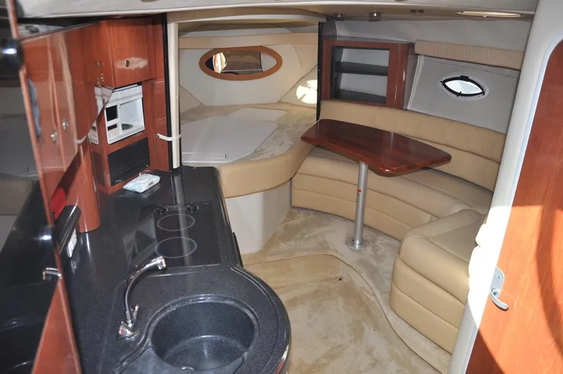 Slide: The Image of 2006 Monterey 322 Cruiser interior with kitchen, seating, and dining area. - 13