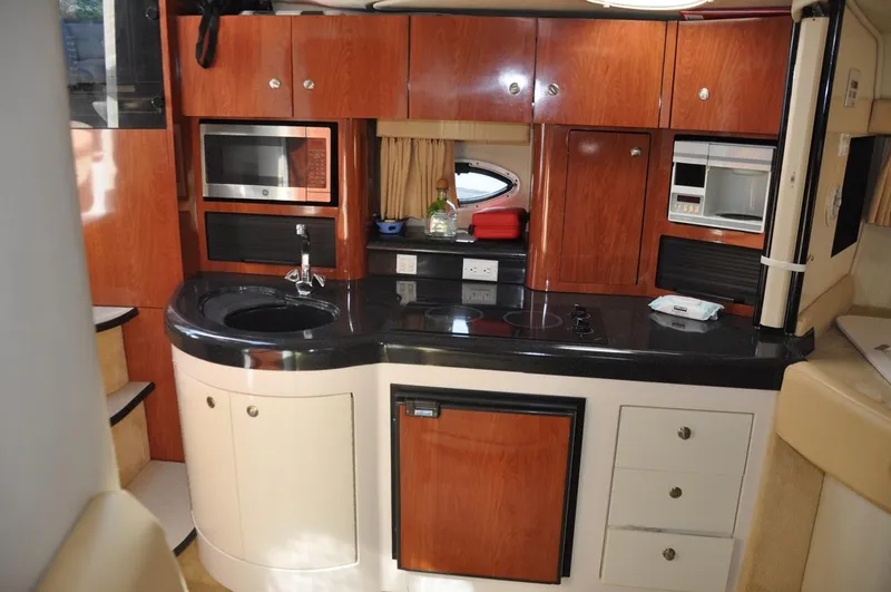Slide: The Image of 2006 Monterey 322 Cruiser kitchen with modern appliances and wooden cabinetry. - 15