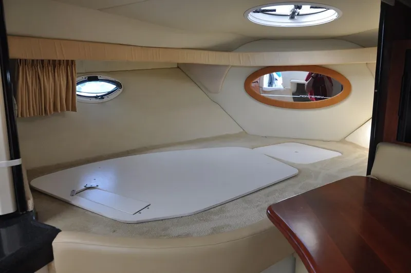 Slide: The Image of Interior cabin of a 2006 Monterey 322 Cruiser yacht with portholes and seating area. - 17