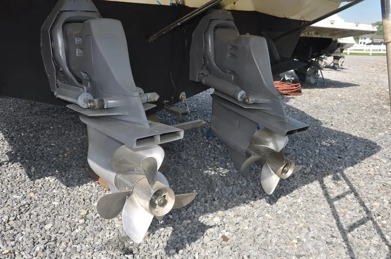 Slide: The Image of 2006 Monterey 322 Cruiser dual propellers on gravel surface. - 22