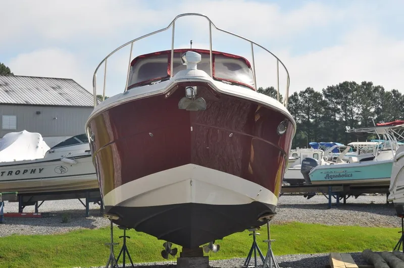 Slide: The Image of 2006 Monterey 322 Cruiser boat on stands in a marina. - 4
