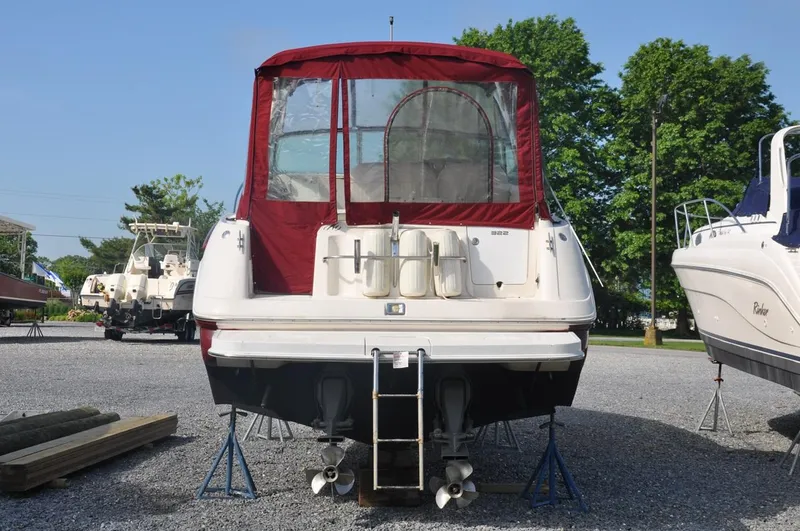 Slide: The Image of 2006 Monterey 322 Cruiser boat with red canopy on stands. - 5