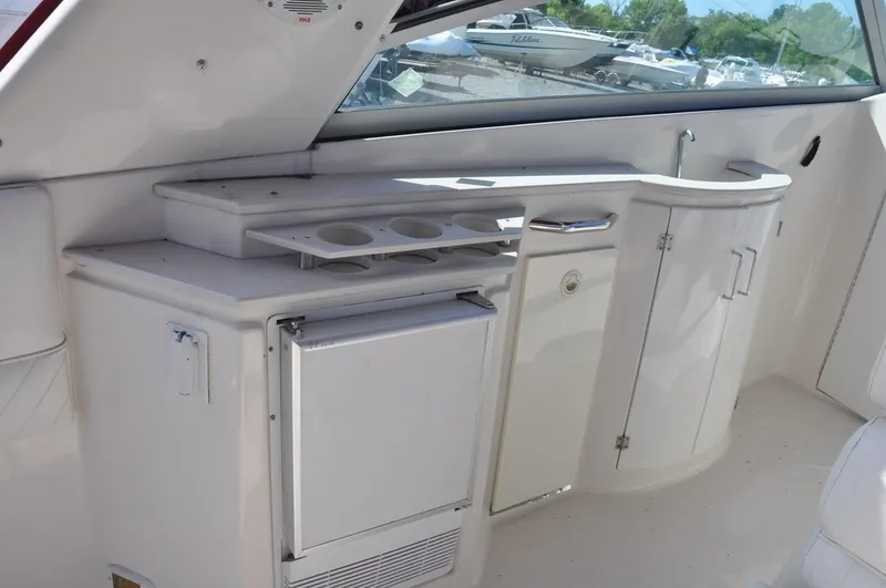 Slide: The Image of 2006 Monterey 322 Cruiser interior with mini fridge and storage cabinets. - 7