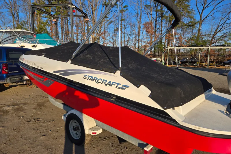 Slide: The Image of 2019 Starcraft MDX 211 O/B boat with cover, parked on trailer. - 1