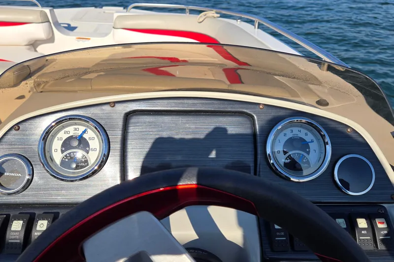 Slide: The Image of Dashboard of a 2019 Starcraft MDX 211 O/B boat with gauges and controls. - 13
