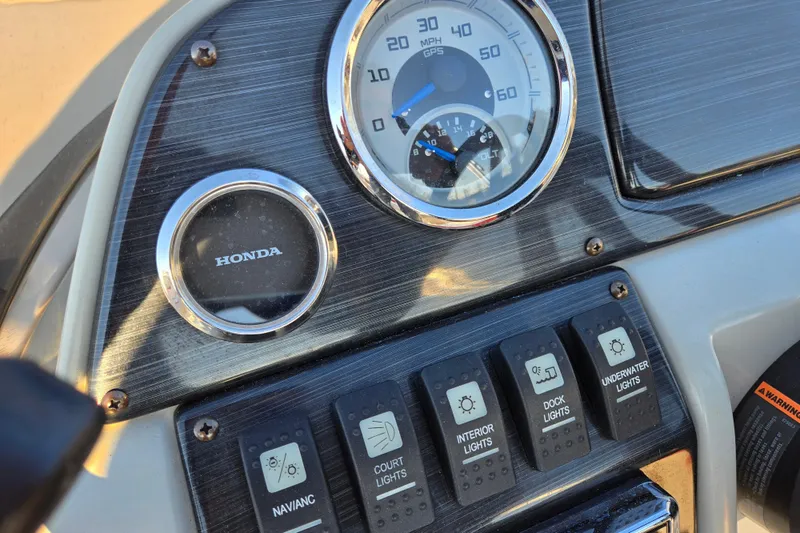 Slide: The Image of Dashboard of 2019 Starcraft MDX 211 O/B boat with Honda gauge and light controls. - 15