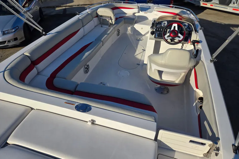 Slide: The Image of 2019 Starcraft MDX 211 O/B boat interior with spacious seating and modern dashboard. - 17