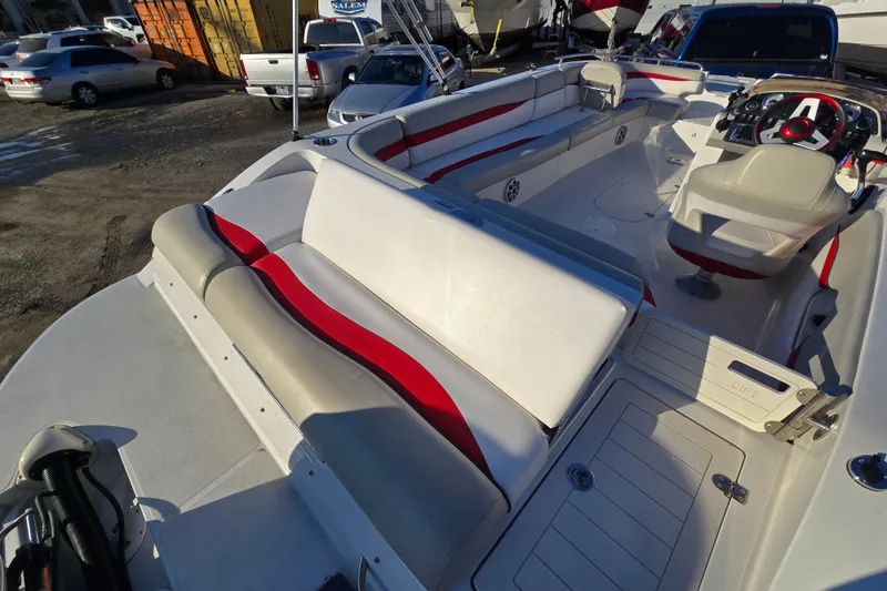 Slide: The Image of 2019 Starcraft MDX 211 O/B boat interior with red and white seating. - 22