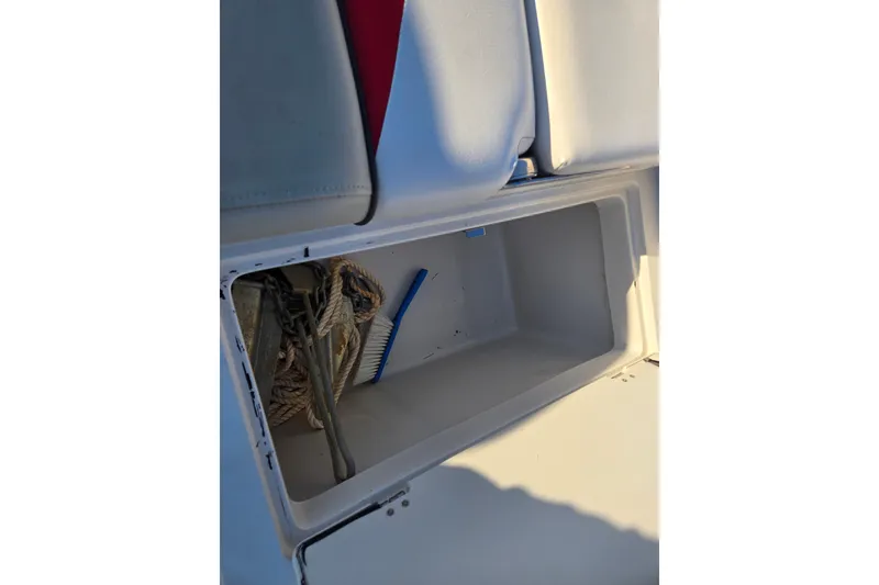 Slide: The Image of Storage compartment in 2019 Starcraft MDX 211 O/B boat with rope and brush. - 23